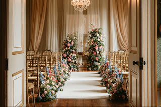 Rise Hall ceremony room in East Yorkshire with floral arrangements and a chandelier in an elegant room set up for the wedding day. Wedding floral installation